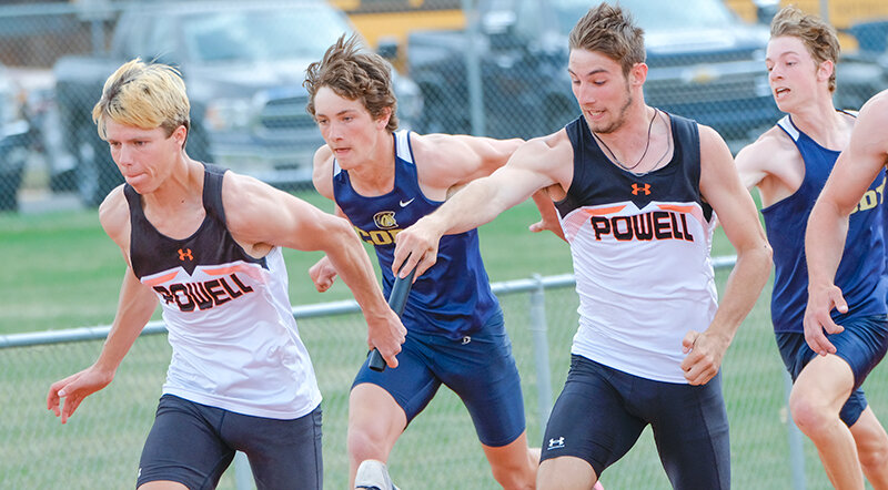 Nathan Dupont (left) takes the baton from Hyrum Jeide during the 4x100 in Cody on Thursday. Powell will attempt to defend its regional team title in Worland this weekend.