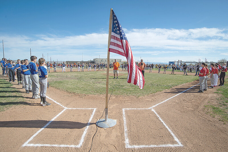 Nevin Jacobs sings the national anthem alongside Travis Jones on Saturday to officially open the Powell Little League season while all 24 teams took the field. Players ages 4-12 can participate in the fun.