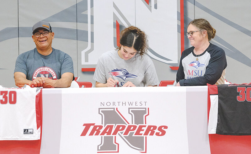 Darla Hernandez is flanked by her parents Mike (left) and Marceen as she signs to continue her collegiate basketball career.