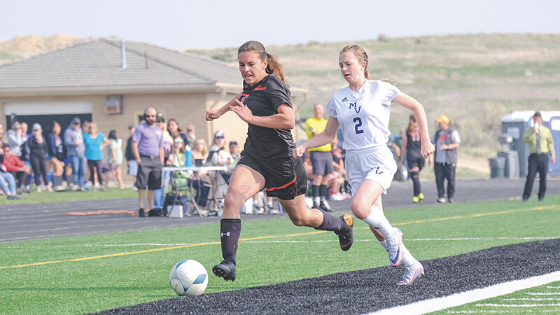 Mary Shopa races down the sideline ahead of a Mountain View defender on Friday. The Panthers won their second ever game at the state tournament on Friday over the Buffalos.