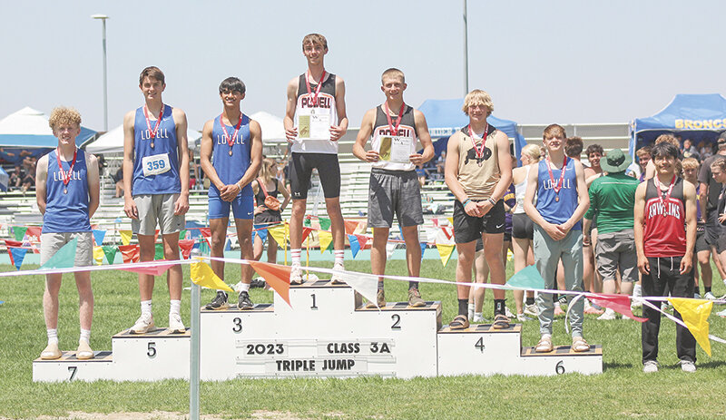 Isaiah Woyak (middle) and Cody Seifert finished first and second in the triple jump, with both jumpers nearly a foot ahead of third place.