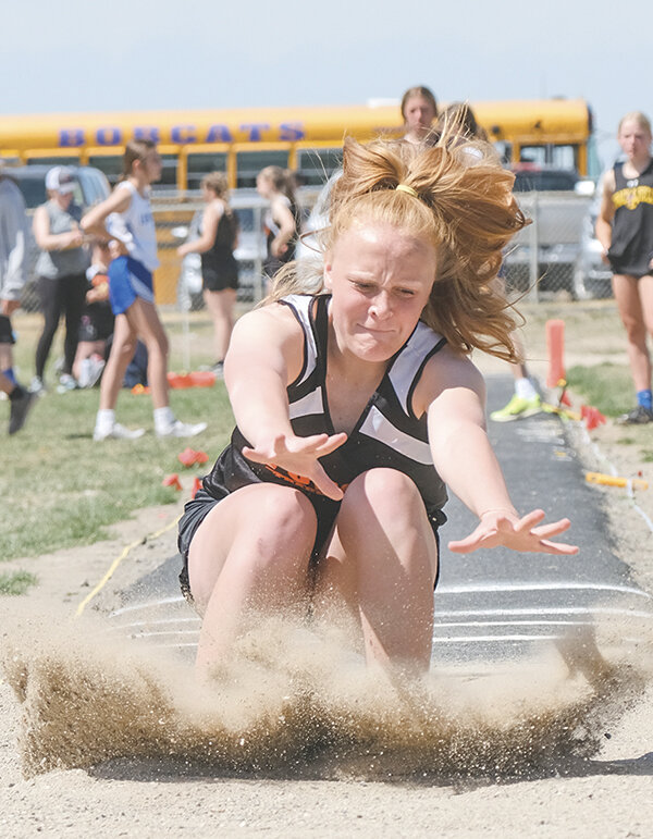 Peyton Ott lands in the sand during a meet in Lovell earlier this season. The Cubs wrapped up the spring track season at the Best of the Best in Lander on May 9.
