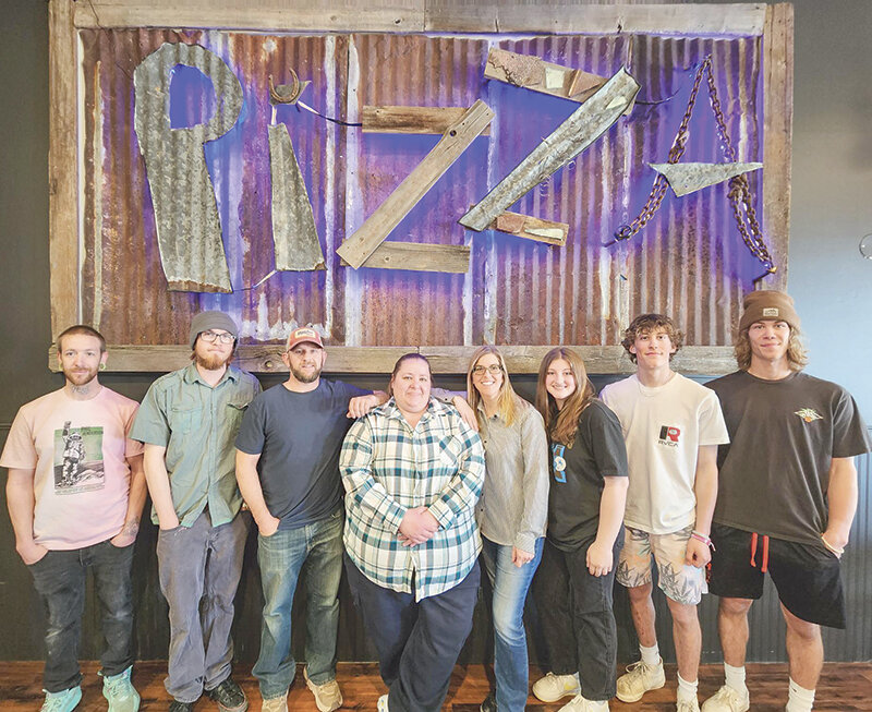 New owners Erynne and Ryan Selk gathered with the staff at Tossers, which includes, from left, Chris, Aaron, Ryan, Autumn (manager), Erynne, Hudson, Carter and Braydin.