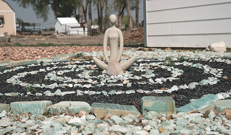A stone statue surrounded by  a paternities of black and green rocks is one feature in the elaborate rock garden surrounding Eternal Ice Enterprises on Lane 11 1/2. The Center has been open for a total of 30 years.
