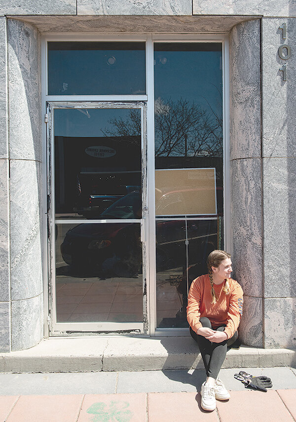 Alleigh Richardson, owner of Bent Corner Framing, takes a break from renovating Powell’s historic First National Bank building earlier this month. Richardson purchased the building last year and is working to return it to its once great prominance on Main Street.
