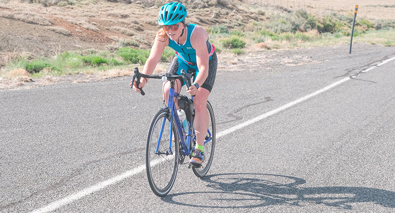 Women’s winner Kinley Bollinger keeps her focus during the 15.5 mile bike ride.