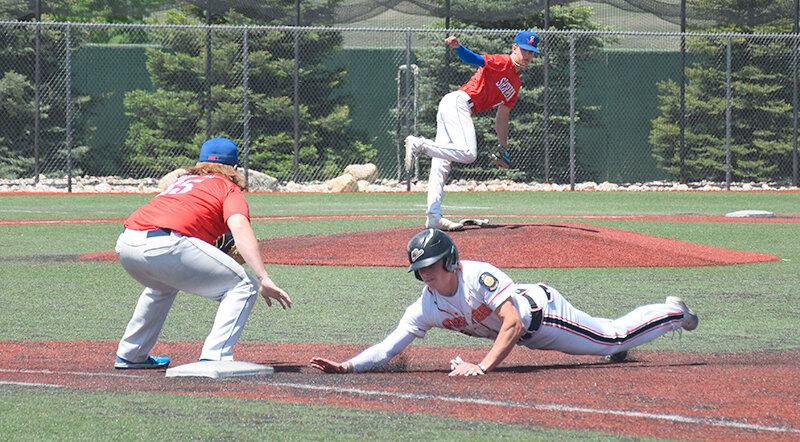 Brock Johnson dives into the Gillette turf trying to beat a pickoff attempt by the Sheridan Trooper pitcher on Monday. Powell will head back out on the road this weekend to Billings and Sheridan.