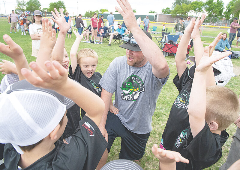 River Turtles coach Chris Baumann leads his team in celebration Tuesday night after the team played the Grasshoppers in the T-ball division of the Powell Little League. Players from age 4-6 field six teams in the division meant to encourage players to have fun in their introduction to the sport.