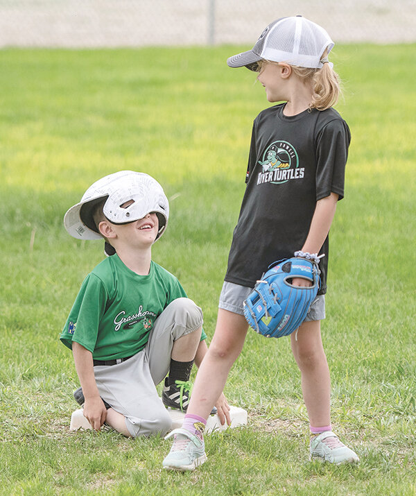 Grasshopper Rex Christofferson gets a laugh out of River Turtles player Joy Reekers (covering second base) during their game Tuesday at Homesteader Park.