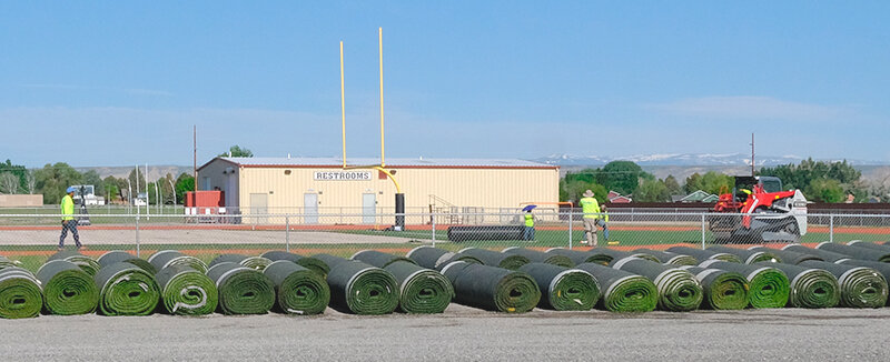 Rolls of turf lay in the gravel lot east of Panther Stadium on Monday, with pickup scheduled for Tuesday morning from 8 a.m. until 11 a.m.