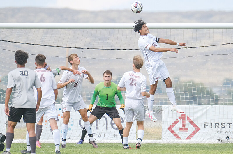 Daniel Gargallo Saavedra (right) leaps up to get a header on a corner for the Trappers during a match against Central Wyoming.
