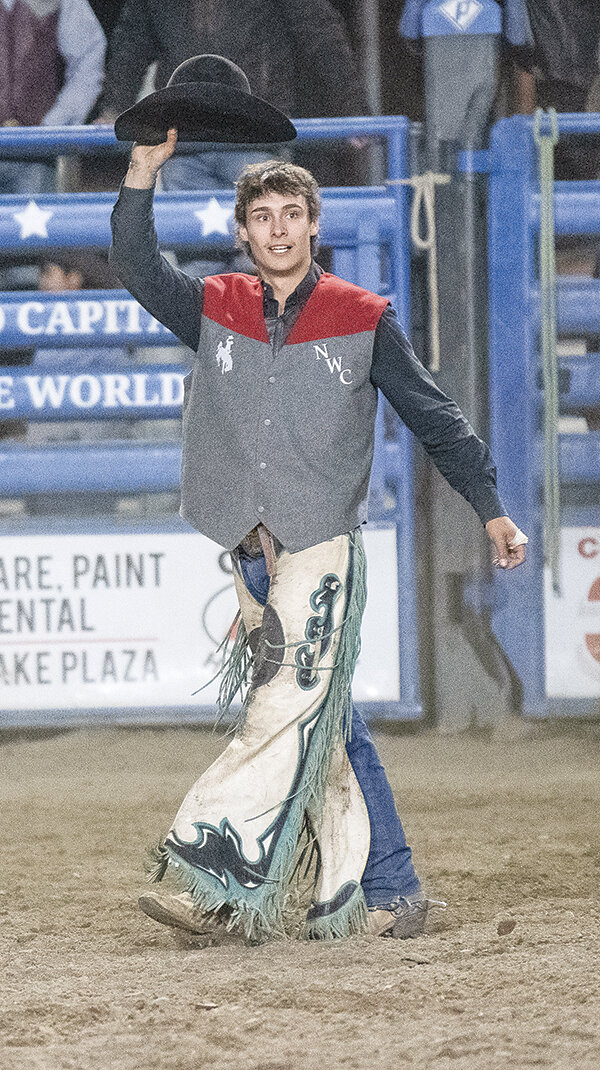 Dylan Young acknowledges the crowd after taking first in the saddle bronc on Friday after earning a score of 79 in the Trapper Rodeo.