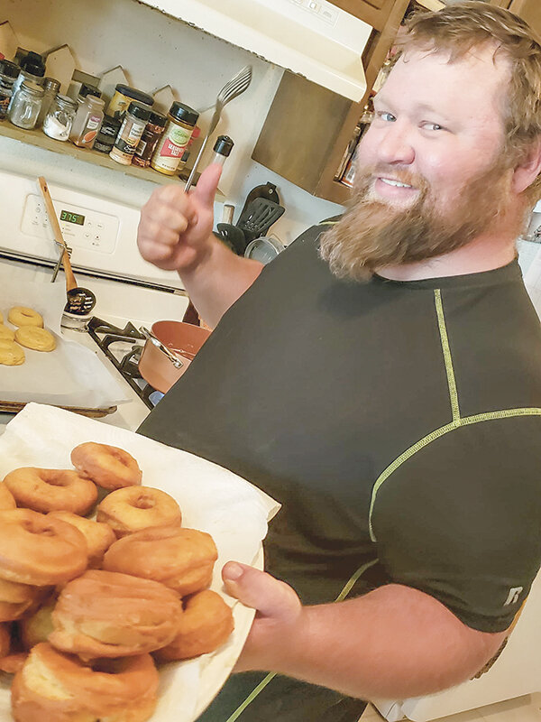 The Dustin’s Pantry logo incorporates Dustin Rhodes’ nickname ‘Ginger Beard Man’ and shows him holding a plate of freshly baked donuts. Rhodes was an avid baker and oftentimes the family cook.