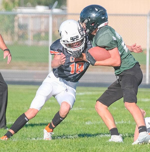 Karcher Foley wraps up a Worland runner as the eighth grade team finished 6-1 and earned the 2023 conference title.