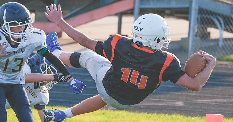 Ethan Ely dives for the pylon during a game against Cody in September. The Cubs dominated en route to an undefeated 2023 season.