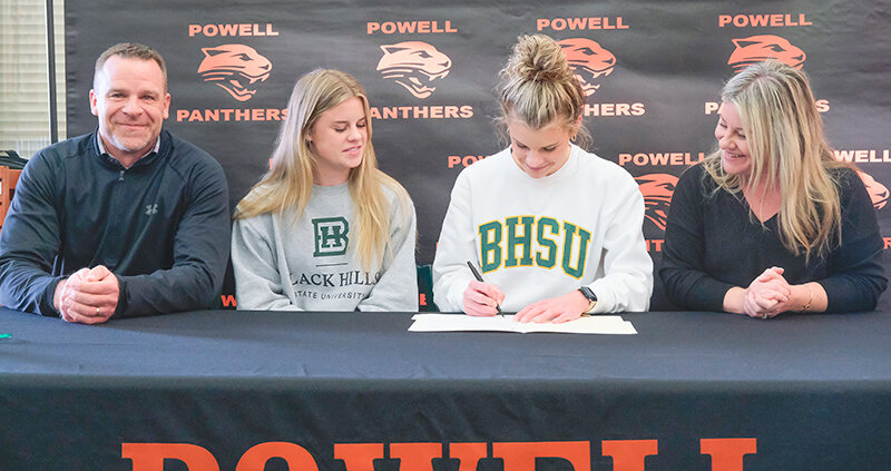Brynn Hillman signs her letter of intent to continue her cross country and track careers at Black Hills State University next fall. From left: Jason Hillman, Jenna Hillman, Brynn Hillman and Amy Hillman.