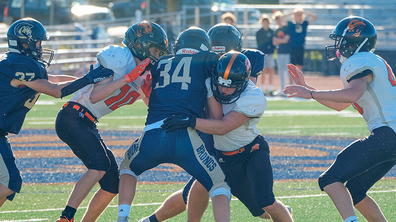 Broc Frank (left) and James Emmett (middle) tackle a Cody runner during the final froshmore game of the season in October. The younger Panthers finished with a 5-4 record in 2023.