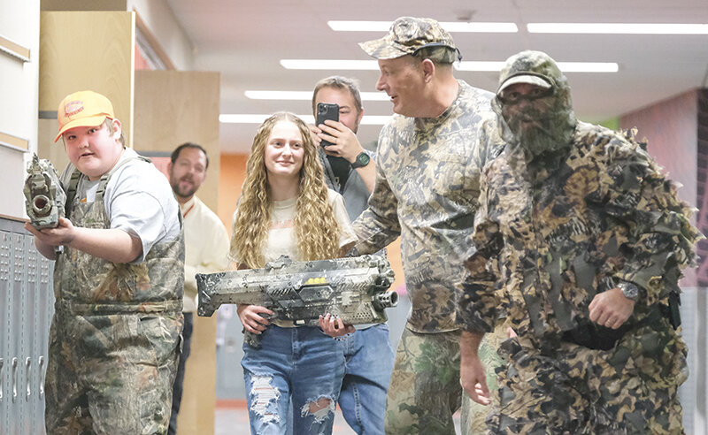 Powell Middle students Alex Rodriguez (left) and Autumn Weckler are guided on the turkey hunt by teacher Bryan Bonander and School Resource Officer Paul Sapp. Students are chosen based on a $1 raffle and the proceeds go to a different family or charity each year.