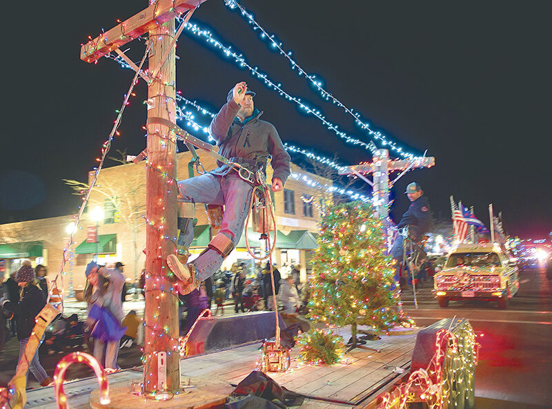 The Garland Light and Power float featuring lineman Josh Serr and apprentice lineman Jason Fields, who is also Powell Volunteer Fire Department’s assistant chief, finished in second place during the Powell ChristmasFest Lighted Parade on Saturday.