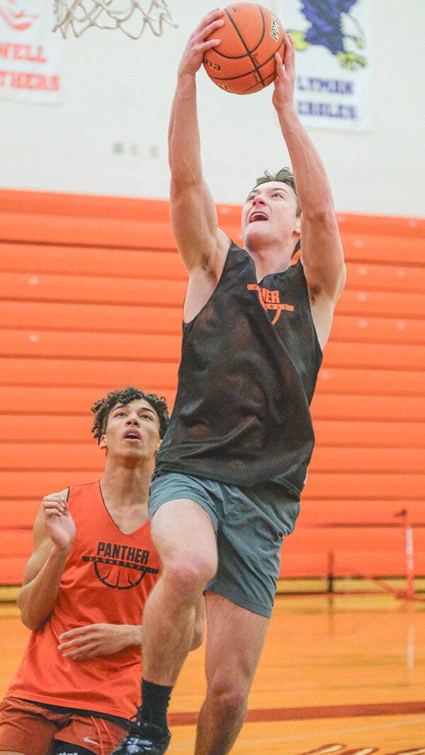 Senior Trey Stenerson skies for a layup against junior Alex Jordan with the Panthers eyeing a strong season this year after making the state tournament the past two seasons.