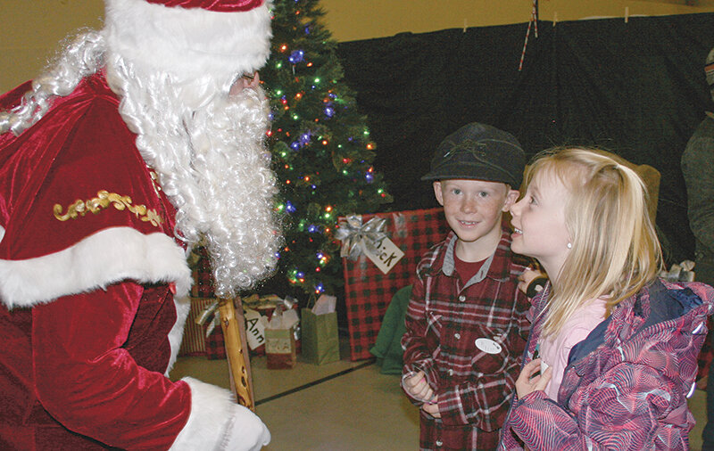 Santa Claus, a good friend of Todd Bentley, visited with Ryder Whisler, 7, and Danali Tillery, 7, at the Clark Pioneer Recreation Center for the Clark Christmas Jingle.