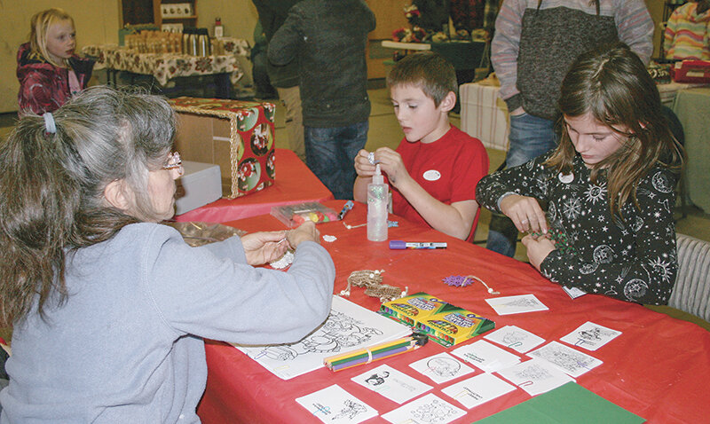 Shirley Bentley ran the arts-and-crafts table for many kids, including Devin Stoker, 8, and his sister, Becca, 10.