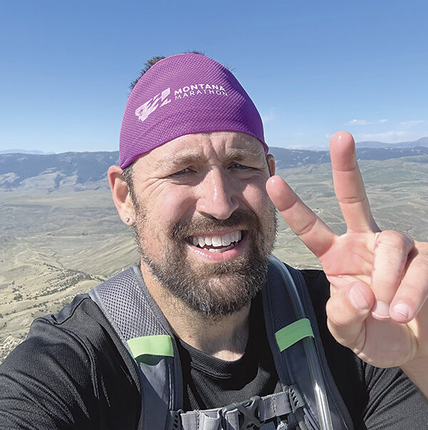 David Holland flashes a peace sign after running Heart Mountain. Last summer Holland ran the mountain two times consecutively while helping a runner train for a race in Big Sky.