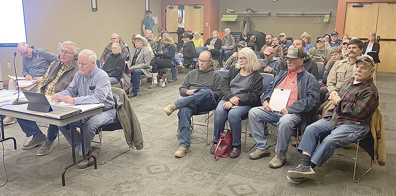 Cody resident Dave McMillan (left) and Sen. Dan Laursen (R-Powell) present their group’s request for Park County to hand count ballots in this year’s elections as dozens of their supporters fill out the Grizzly Room on Tuesday at the Cody Library.