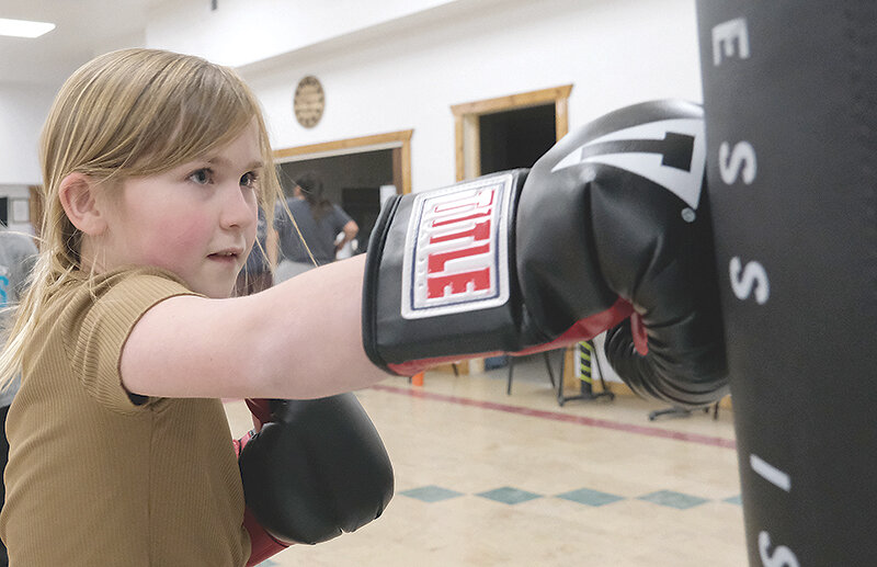 Delilah Bieber focuses on her form while striking the heavy bag during the first practice of the Post 26 Boxing Club. The American Legion-founded program is free to all Powell youth and aims to help them develop character.