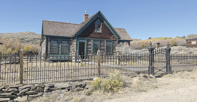 A lovely South Pass City home is complete with a wrought iron fence.