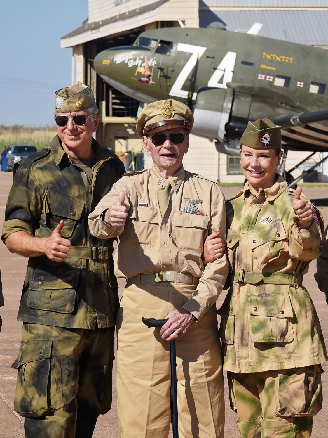 Pictured from left are WWII Airborne Demonstration Team Member Rodney Roycroft, LTC Dave Hamilton (Ret.) and WWII Airborne Demonstration Team Member Kat Healey at Frederick Army Airfield during Summer Jump School 2022.