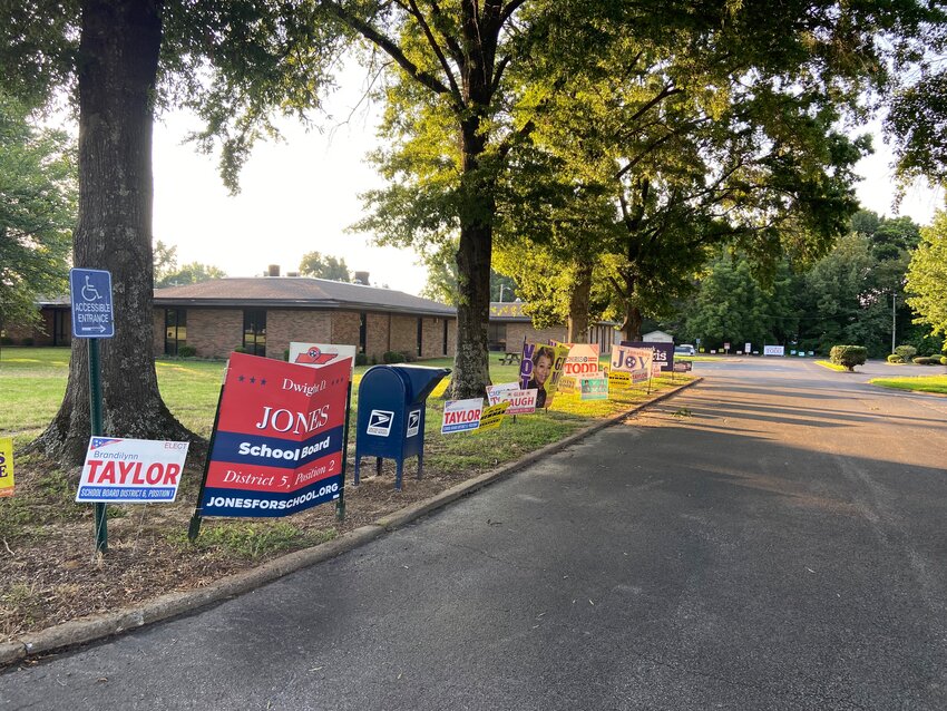 Signs line the driveway into the parking lot at the Madison County offices on North Parkway where early voting happens.