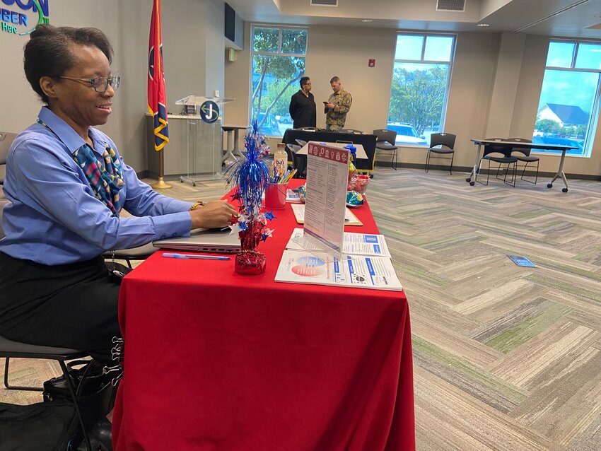 A representative from American Job Center sits at AJC’s table at Persevere’s job fair at The Greater Jackson Chamber on April 29.
