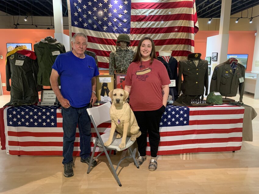 Larry and Annah DeBerry showcasing their war memorabilia at the Tennessee River Museum. For those wondering about the dog, Larry DeBerry said, “Dogs are often a part of combat. They may be to provide companionship or they may used for trailing the way for soldiers to move forward.”
