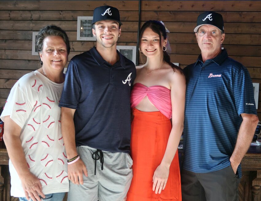 Dalton McIntyre and his family pause for a photo at his celebration party at Hub City Brewing on Wednesday, July 17, 2024.