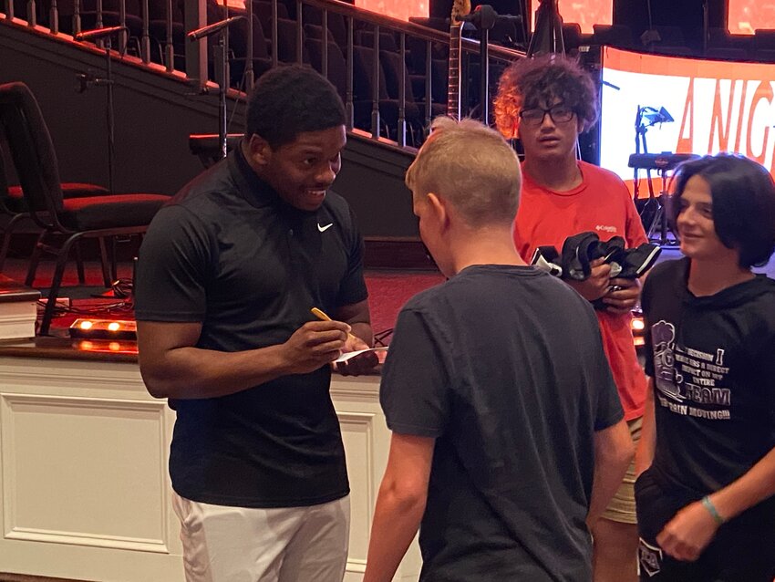 Jabari Small, former running back for the Tennessee Vols and currently signed with the Tennessee Titans, signs autographs after speaking at Englewood Baptist Church on July 17, 2024.