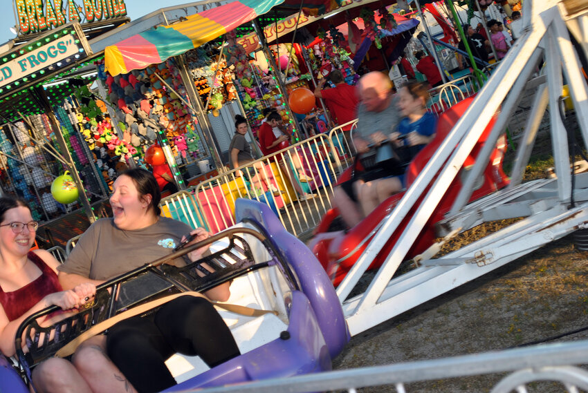 Fairgoers enjoy a ride Monday evening.