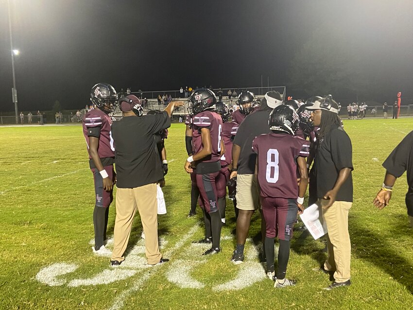 Liberty's coaches talk to their players during a timeout in the fourth quarter of their 7-6 loss to Scotts Hill on Sept. 26, 2024.