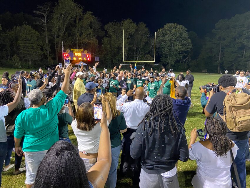 Fans and parents get photos and video as JCM is presented the Commissioners' Cup on Friday.