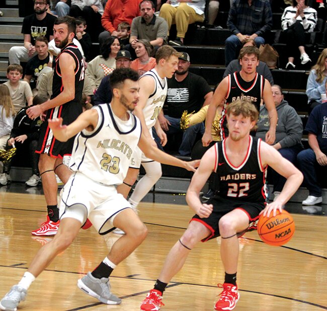 #23 Justice Bell defends at the foul line.