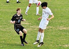 Ixaya Gonzalez heads the ball away.