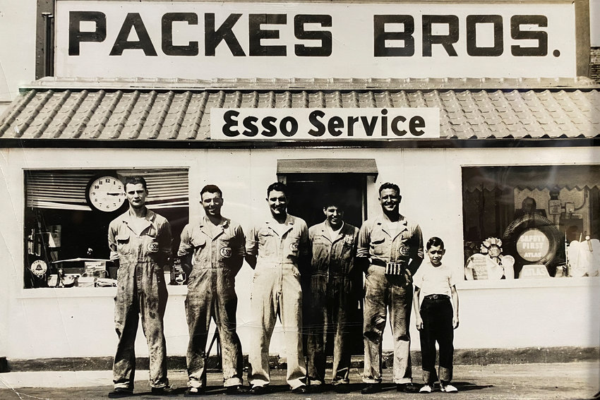 Jimmy Packes stands next to his father, three uncles and cousin in front of the family’s old car service station in Norwood. Packes, who ran the Kingsdale Service Center on Tibbett Avenue and West 230th Street for some 40 years, died last month at 83.
