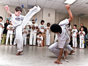 Kai Tsalch, 9, spars with Mateo Gonzalez, 9, as an exhibition of Brazilian martial art by Abada Capoeira at the AmPark Neighborhood School Health Fair on April 20.