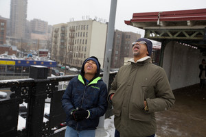 Jorge Pi&ntilde;a, 56, and his son Jorge Pi&ntilde;a, 11, stick their tongues out to catch snowflakes while they wait for the 1 Train at West 238th Street on Monday.