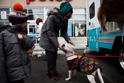 Jayce Rodriguez, left, and Bryalana Santos pet Ellie, a 2-year-old pitbull mix looking for a family to adopt her at an event at Petco last Sunday.