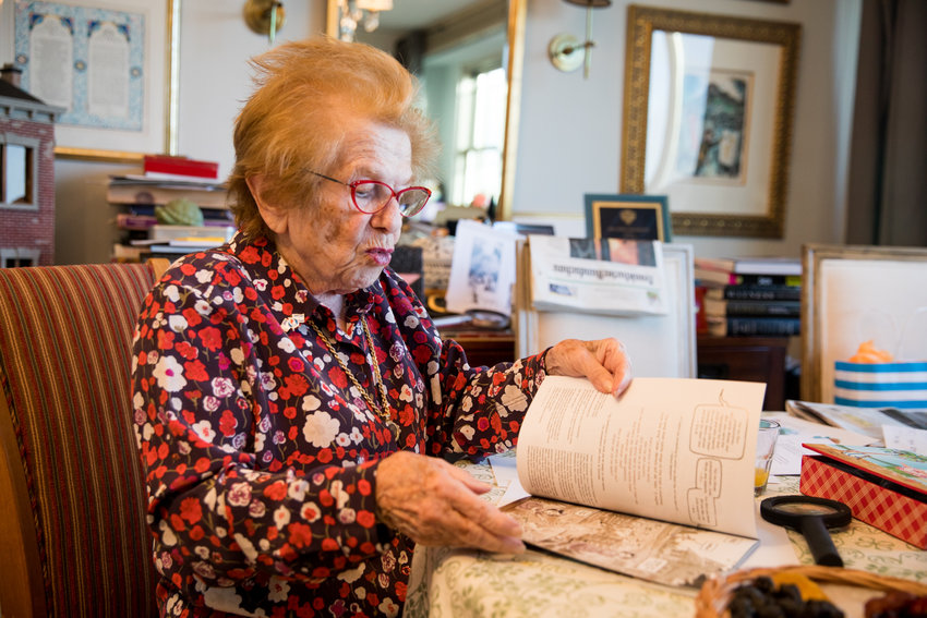 Dr. Ruth K. Westheimer flips through a graphic novel about her life&rsquo;s story, &lsquo;Roller Coaster Grandma: The Amazing Story of Dr. Ruth.&rsquo;