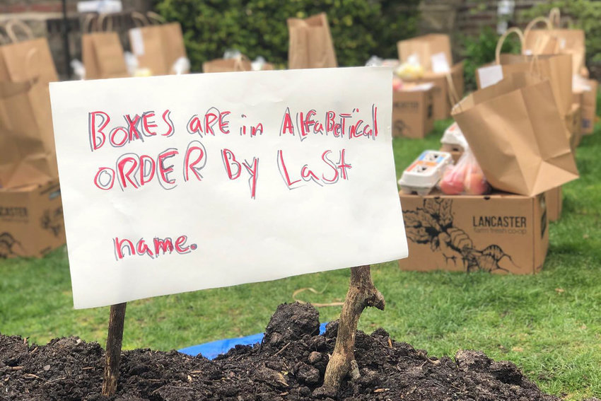 A sign informs customers that &lsquo;farm boxes&rsquo; are organized alphabetically by last name. Moss Cafe owner Emily Weisberg has kept business alive by continuing to buy from the farms she used when her cafe was open, except now she&rsquo;s selling produce directly to people.