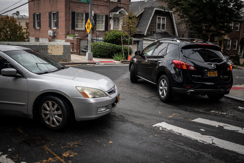 Two drivers barter for space at the mouth of West 238th Street between Cannon Place and Sedgwick Avenue. These three streets were at the center of a recent DOT study to convert this section of West 238th into a one-way street.
