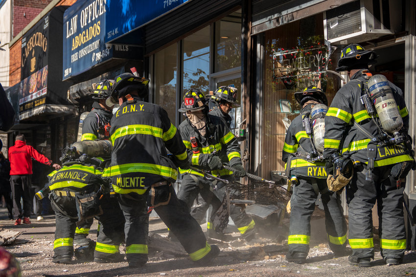 Firefighters pull rubble out of the Picture Perfect Frame store at 267 W. 231st St., on Monday afternoon. The entire interior ceiling collapsed on the shop and its owners, Nohad and Samia Jourdy. Luckily both escaped serious injury.