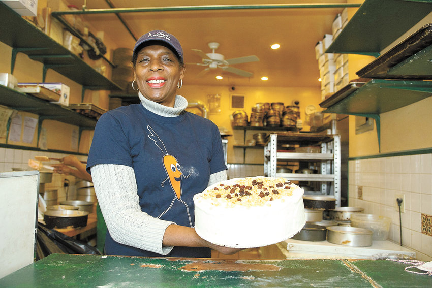 Betty Campbell-Adams, owner, at Lloyd's Carrot Cake, showing one of her prize creations at the store's 30th anniversary in 2016.